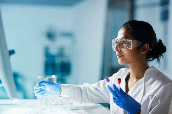 Female researcher wearing protective eyewear in a lab setting