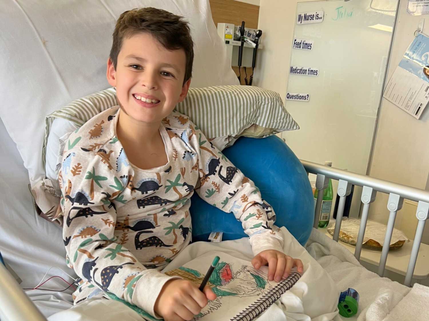George (who has a genetic heart condition) in his hospital bed