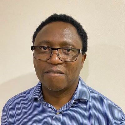 A man wearing glasses and a blue shirt.