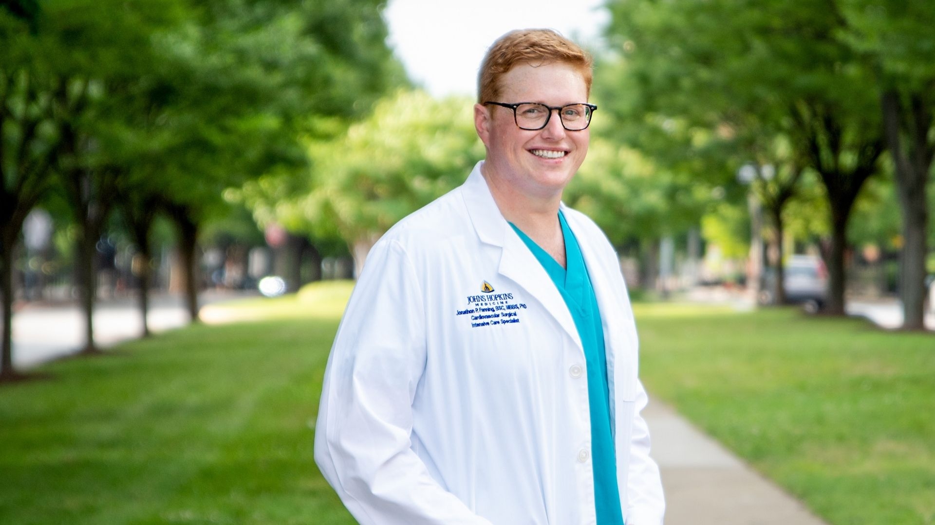 Associate Professor Jonathan Fanning wearing a Johns Hopkins lab coat