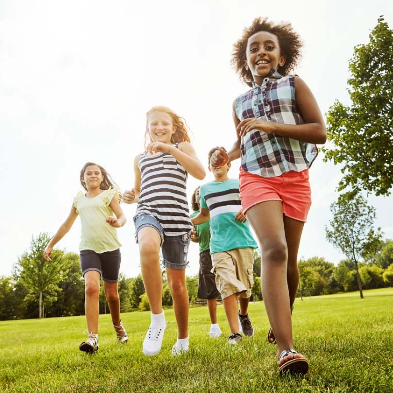 Young girls running outdoors