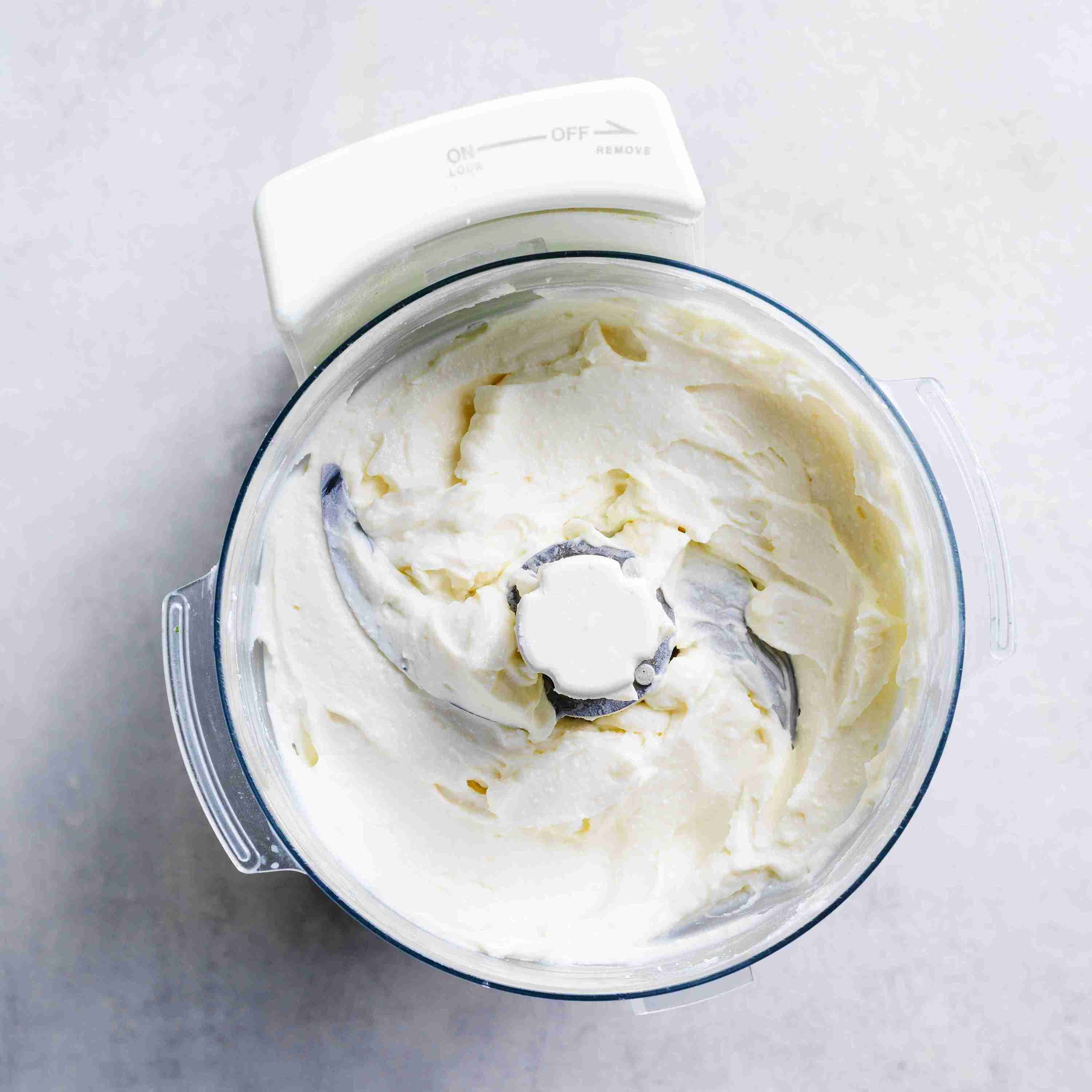 ricotta, vanilla, and icing sugar being blended in a food processor