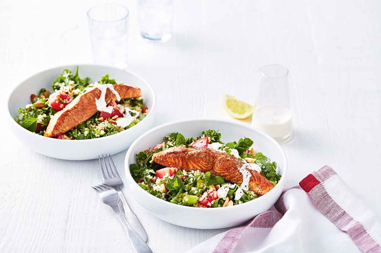 2 plates of Baked salmon with quinoa salad on a table