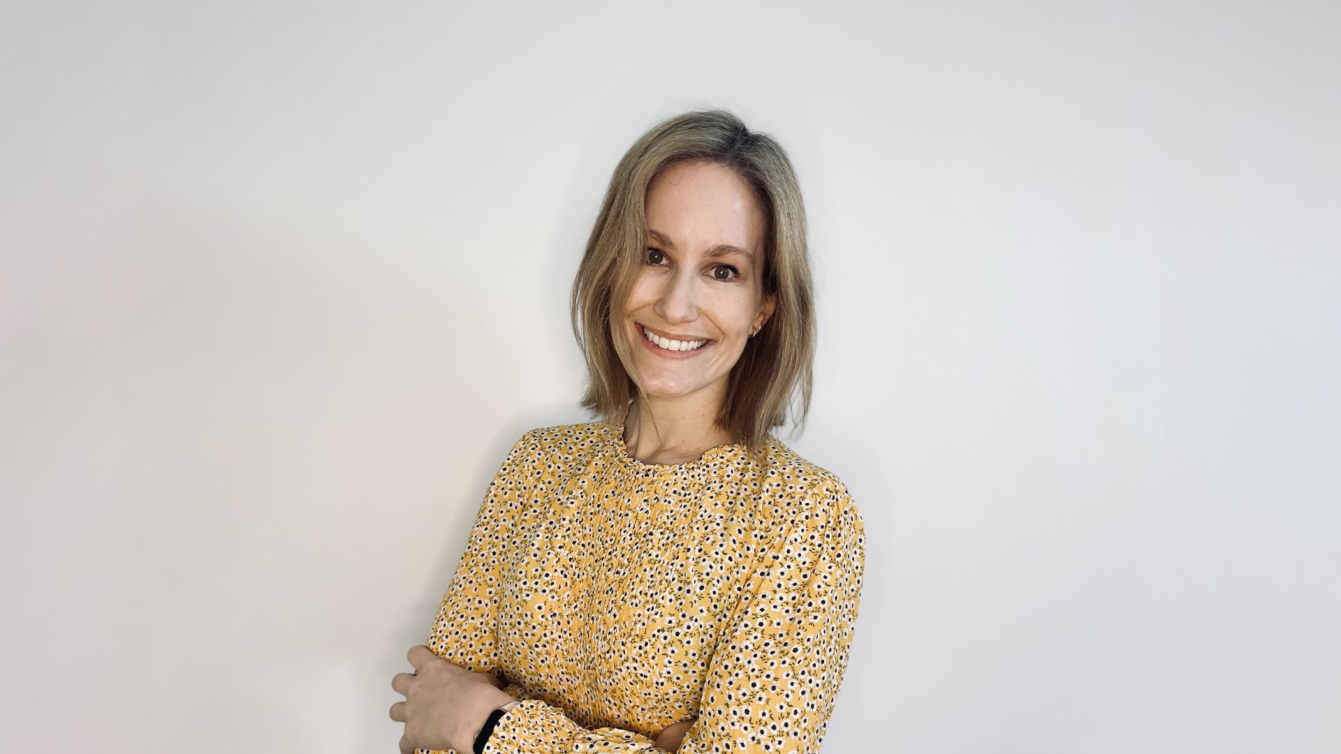 woman wearing yellow dress with a smiling face