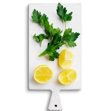 lemon wedges and parsley on cutting board