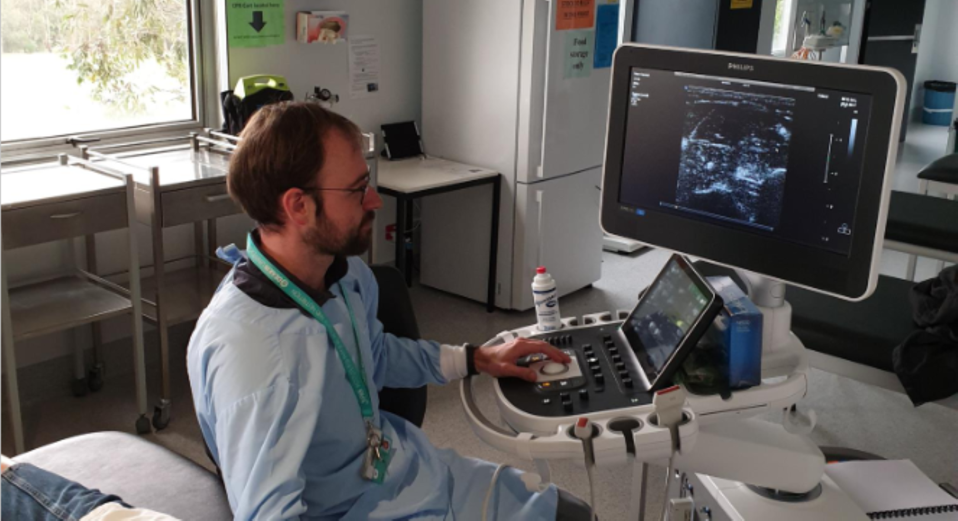 Dr Lewan Parker in scrubs operating medical equipment