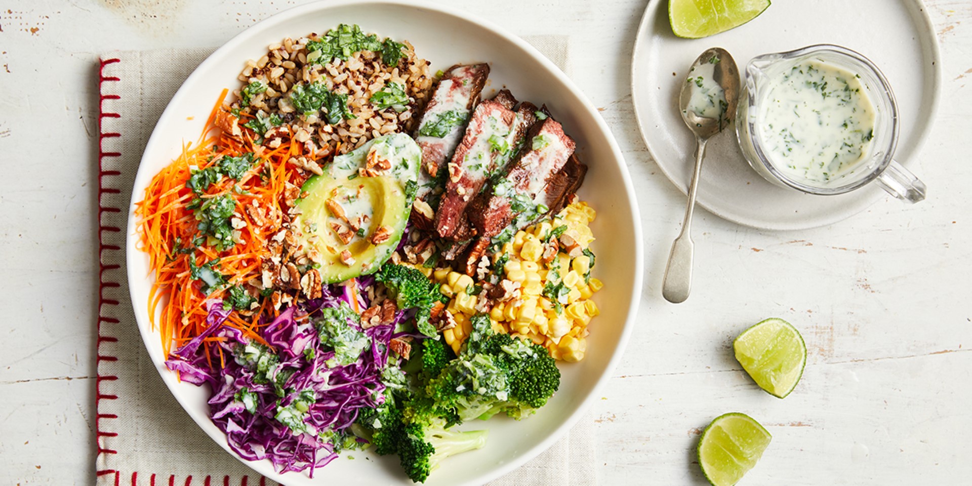 A plate of food featuring a colorful assortment of vegetables, a fresh salad, and a drizzle of dressing.
