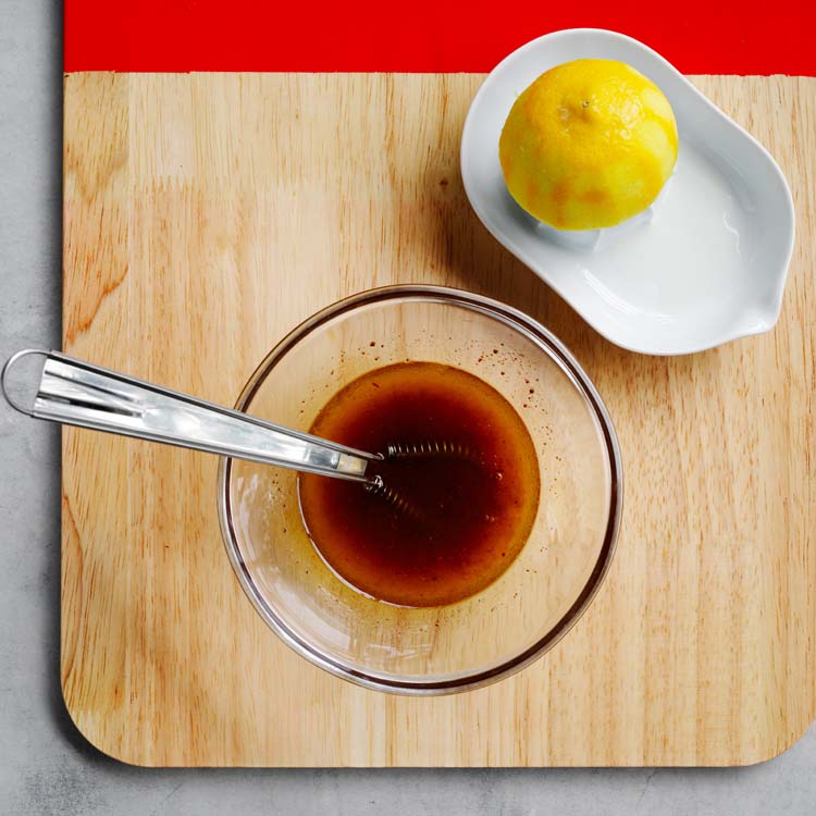 Whisking lemon juice, honey, olive oil and sumac to make the dressing