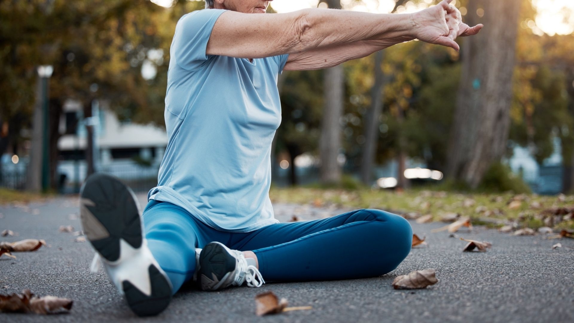 A woman stretching in a park