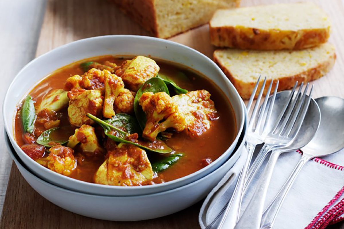 A delicious bowl of curry on a wooden table