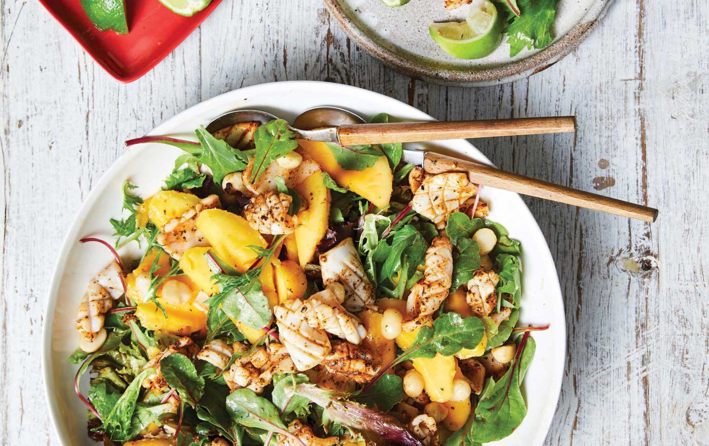 Colourful salad featuring mango, greens and grilled squid