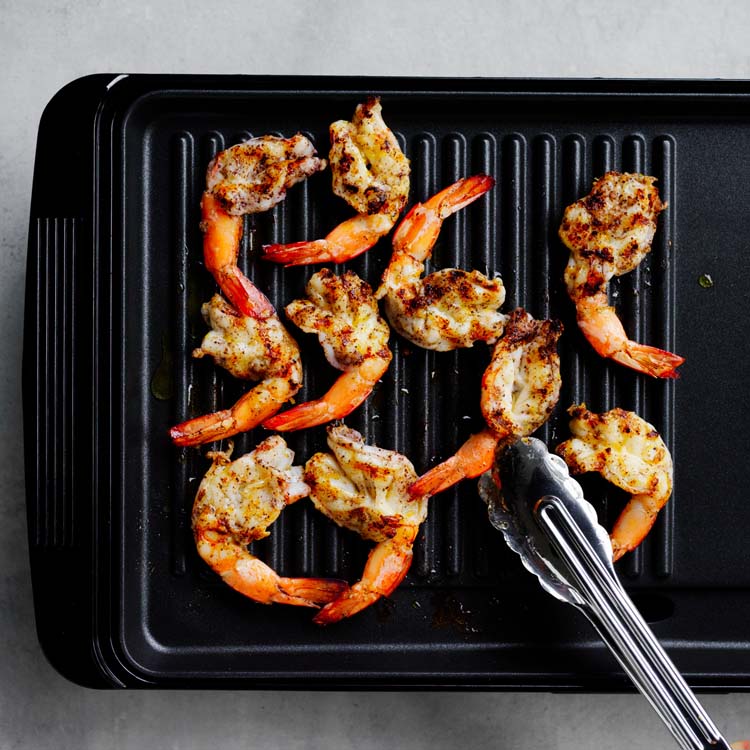 Prawns cooking on a barbecue plate