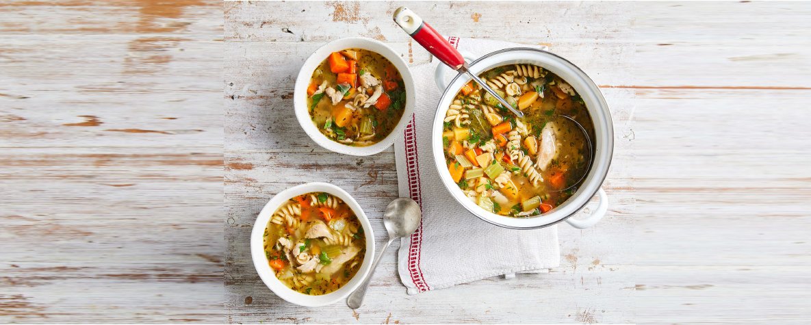 Two hearty bowls of soup filled with savory vegetables and tender meat