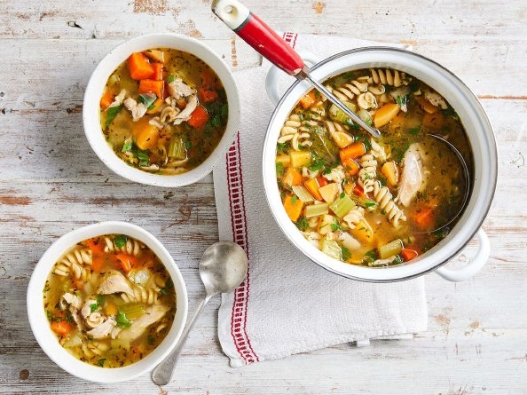 Two hearty bowls of soup filled with savory vegetables and tender meat