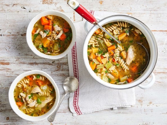Two hearty bowls of soup filled with savory vegetables and tender meat
