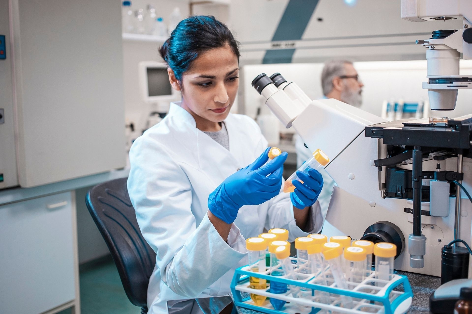 Female Scientist Working in The Lab, Using Microscope