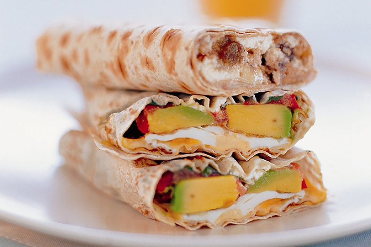 A plate holds three wraps stacked neatly