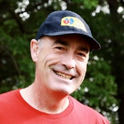 Greg Page smiling in a black Heart of the Nation cap 