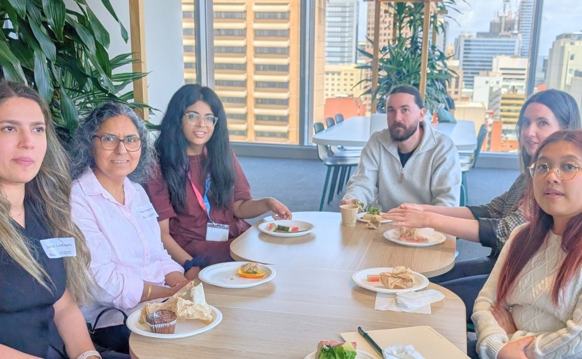 CSANZ research awards showcase attendees sitting at table eating together