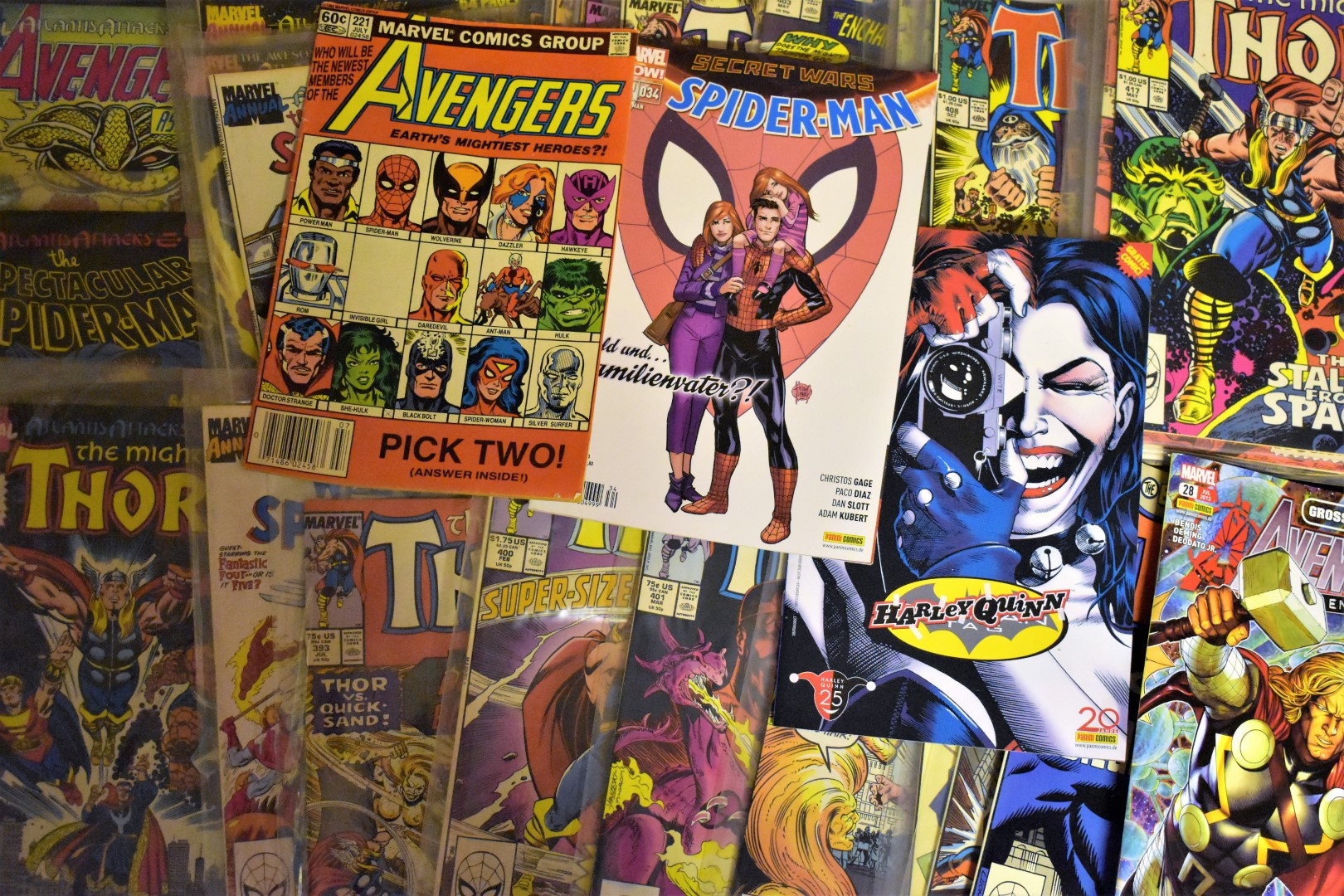 Wall collage of comic book covers featuring superheroes