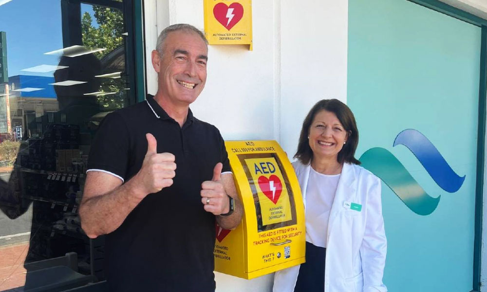 Greg Page, from Heart of the Nation, giving the thumbs up standing with a woman smiling
