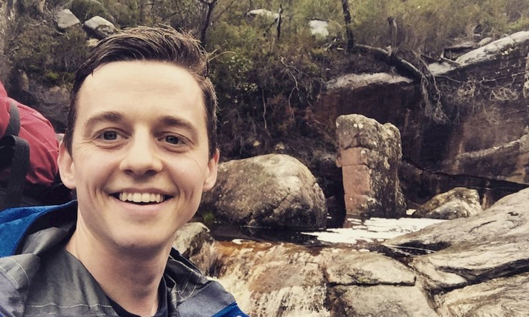Man in the midst of nature with a smiling face