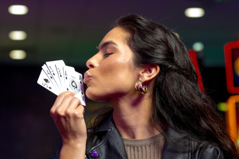 Woman blowing on cards