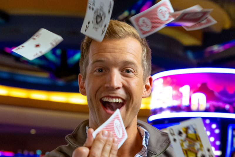 Man throwing playing cards in the air