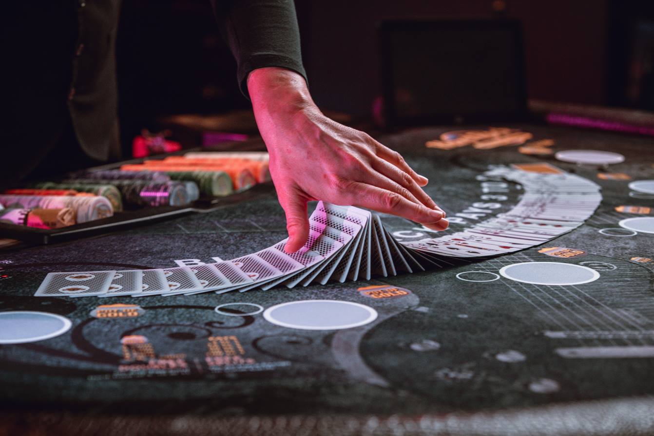 Dealer holding cards