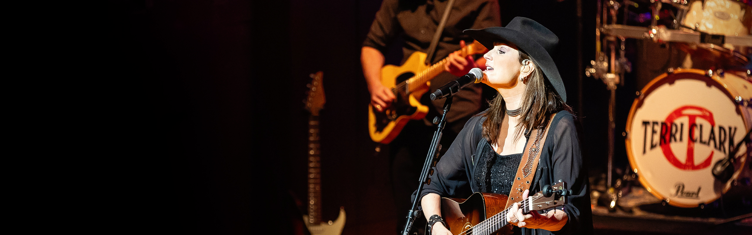 Image of Terri Clark melting facts by playing guitar