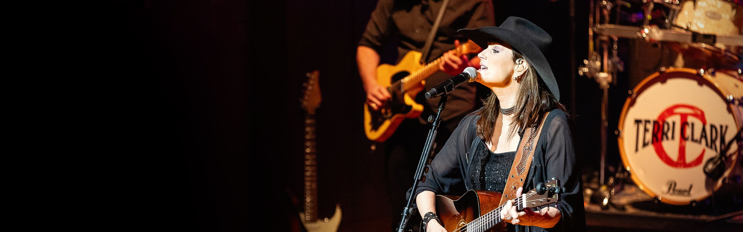 Image of Terri Clark melting facts by playing guitar