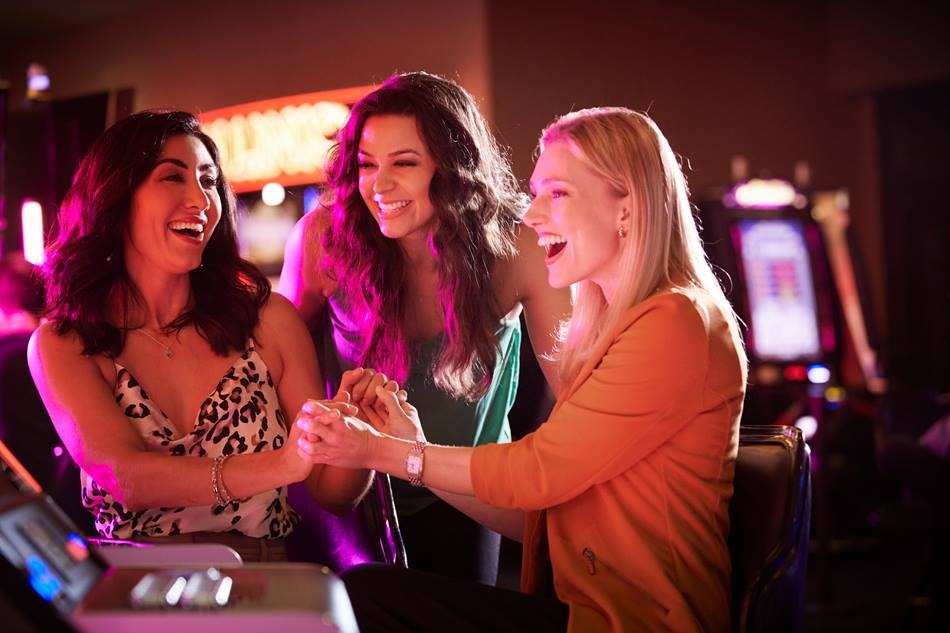 Women holding hands celebrating