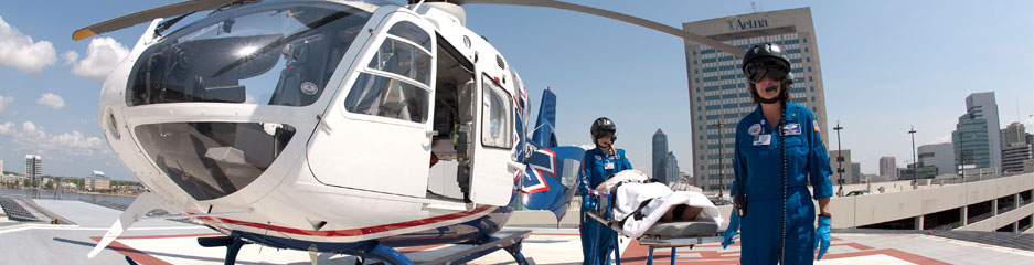 helicopter pilot and flight nurse walking next to the life flight helicopter 