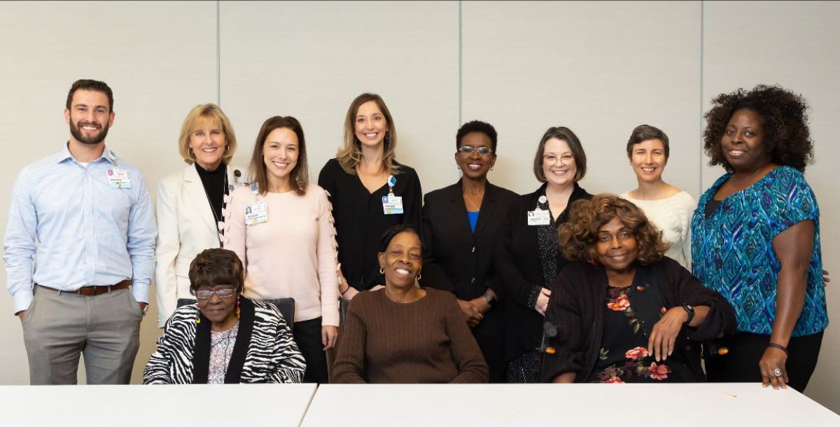 A group of people with community members who benefited from Aging True services joined a luncheon hosted by Baptist Health.