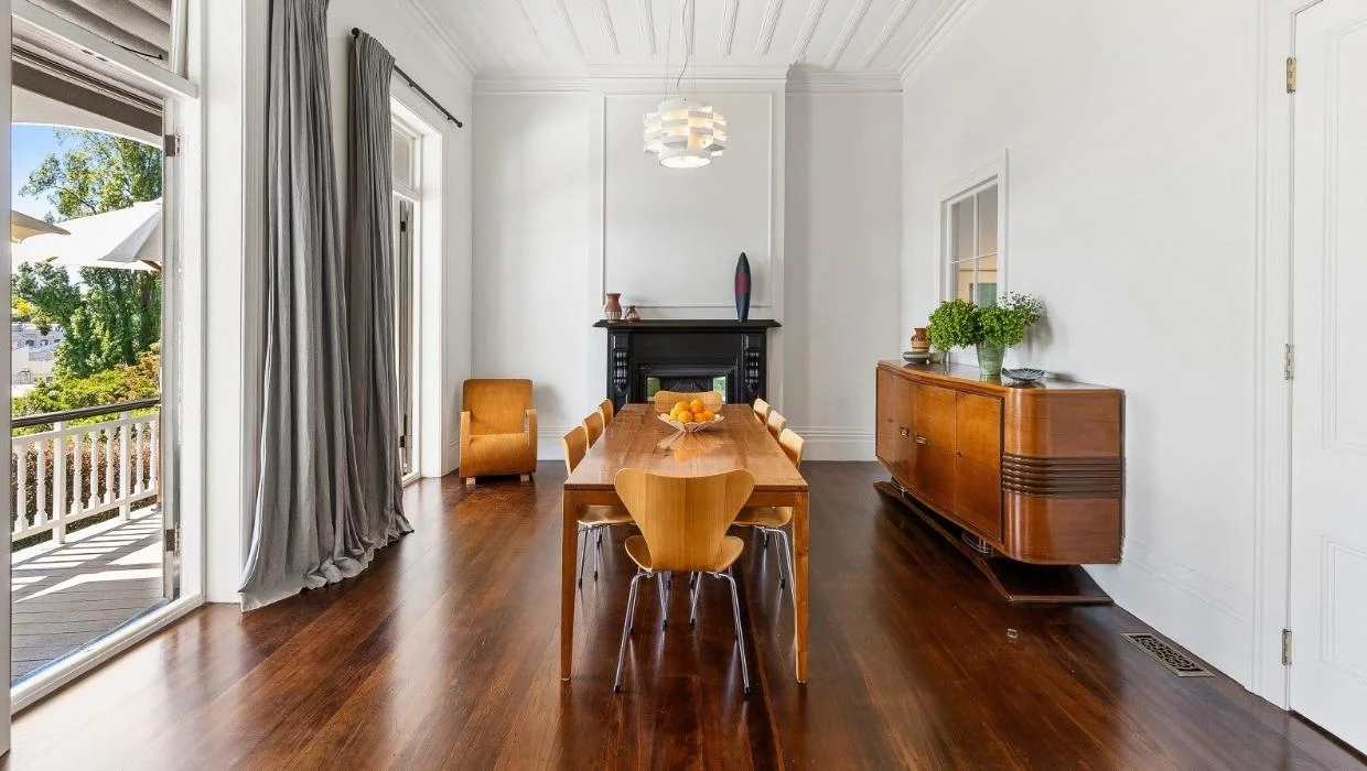 The formal dining room opens onto the terrace, and includes several vintage architectural features, such as the fireplace, and ceiling.