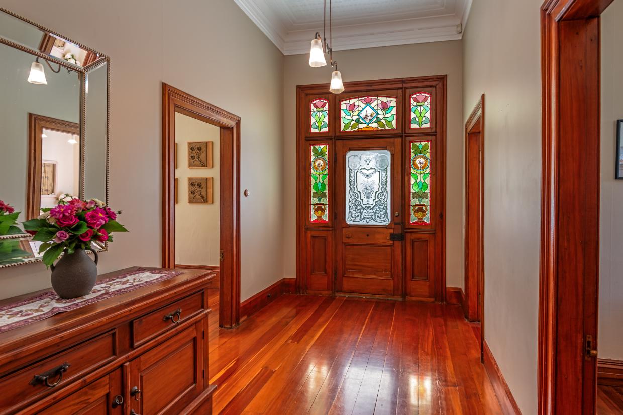 A beautiful stained glass doorway and wide hall ensure the entry is in keeping with the grandeur of the architecture.