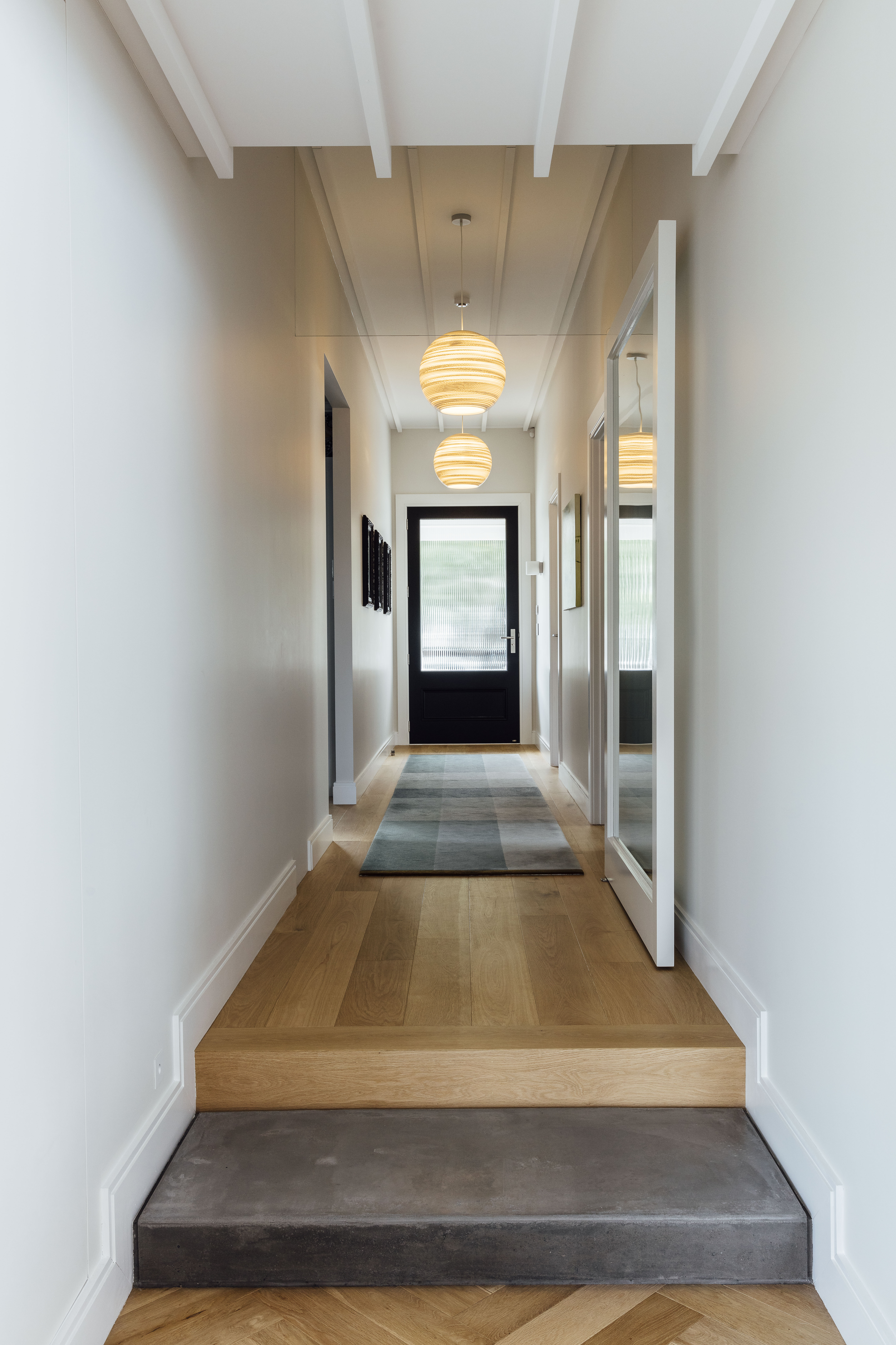 ‘Generally, our approach is to acknowledge that villas are generous and simple, and we followed that by making all our doors, windows and spaces generous and simply linked,’ says Malcolm. ‘We also allowed the central hallway to continue notionally right through to the back wall. There’s something nice about looking right through a house.’ Traditional accents he’s reimagined include the ceiling battens, which aren’t intricate but dressed and lead along the hallway through a frameless glass highlight window past a pivot door and into the dining area.”