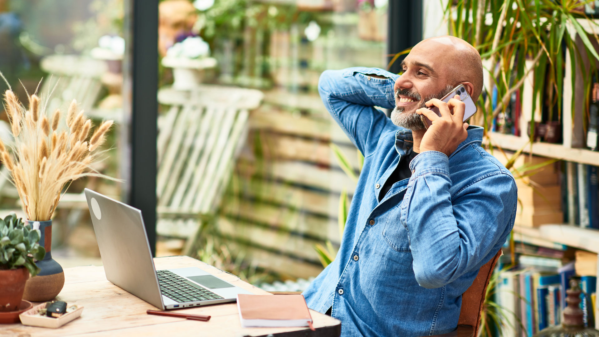 Man smiling on the phone while negotiating his salary.