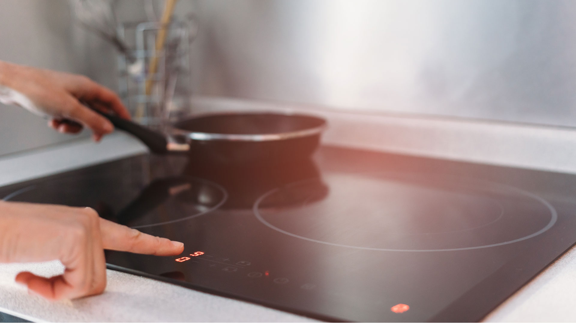 A Kiwi using an induction cooktop in their kitchen.