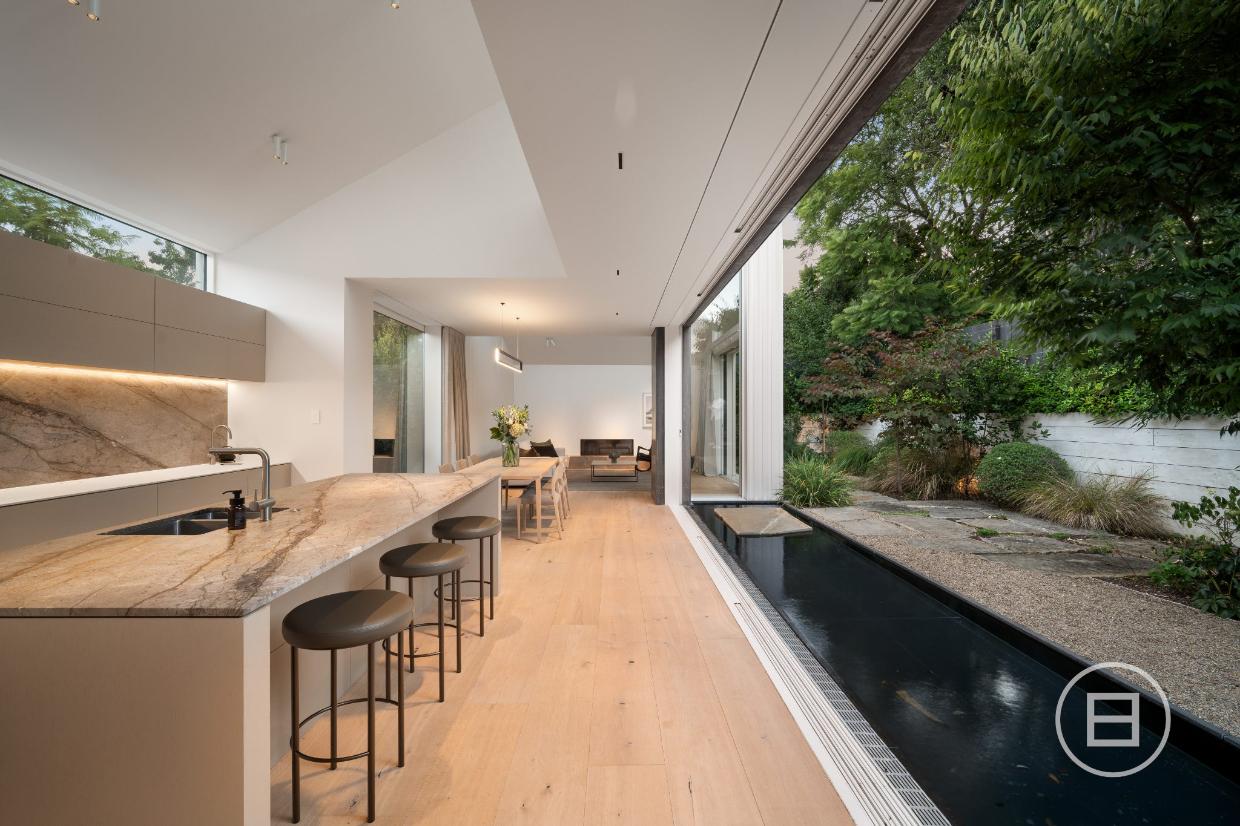Rooms in the extension open to a courtyard on the west side, with a reflection pool 