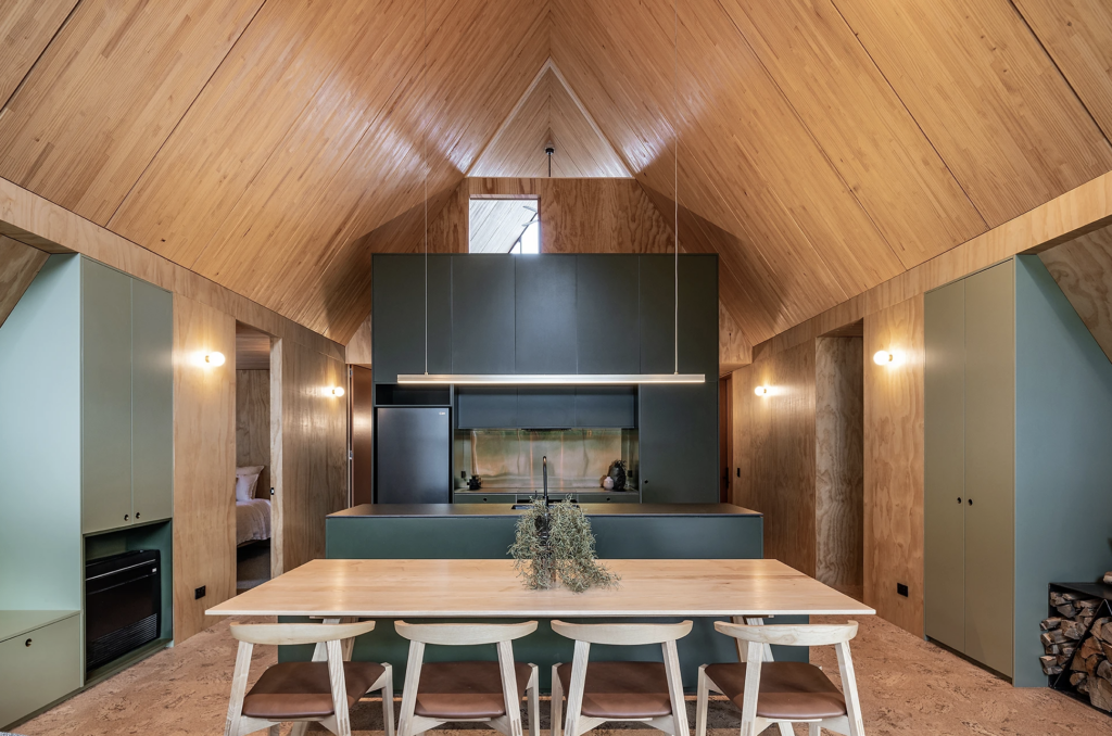 The hero of the kitchen is the rear cabinetry, painted in Resene Log Cabin; the lighter, more whimsical hue of Resene Flax was used for storage cupboards to either side