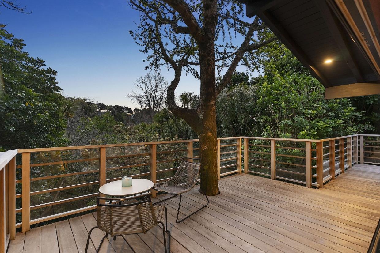 Wrap-around decks were added to maximise the connection with the bush. Photo: NZ Sotheby's