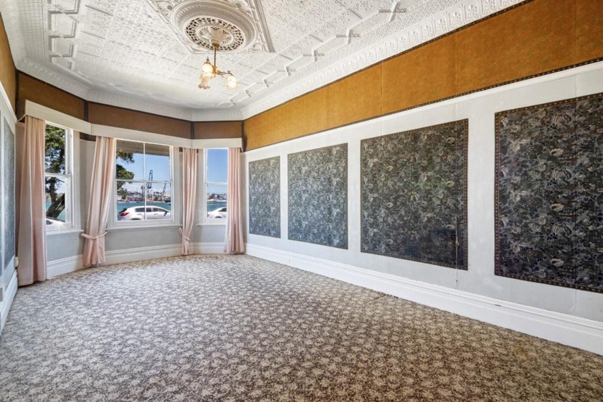 Original wallpaper and decorative ceiling remains.