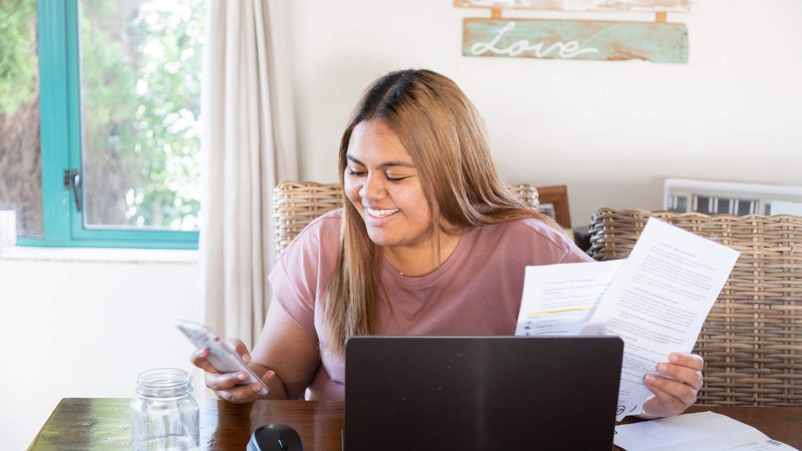 Lady looking at laptop and bill