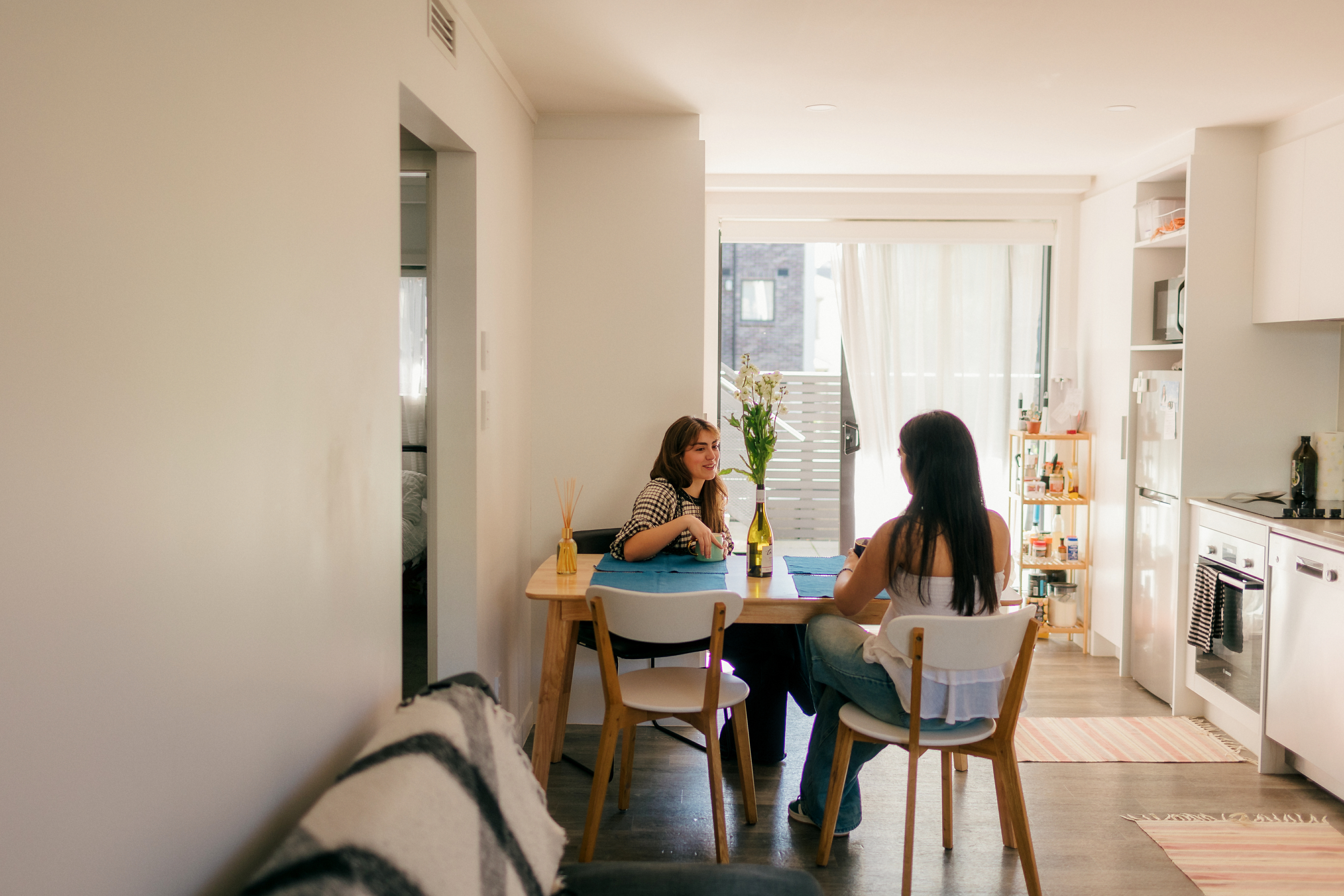 The sisters chatting at their dining room table