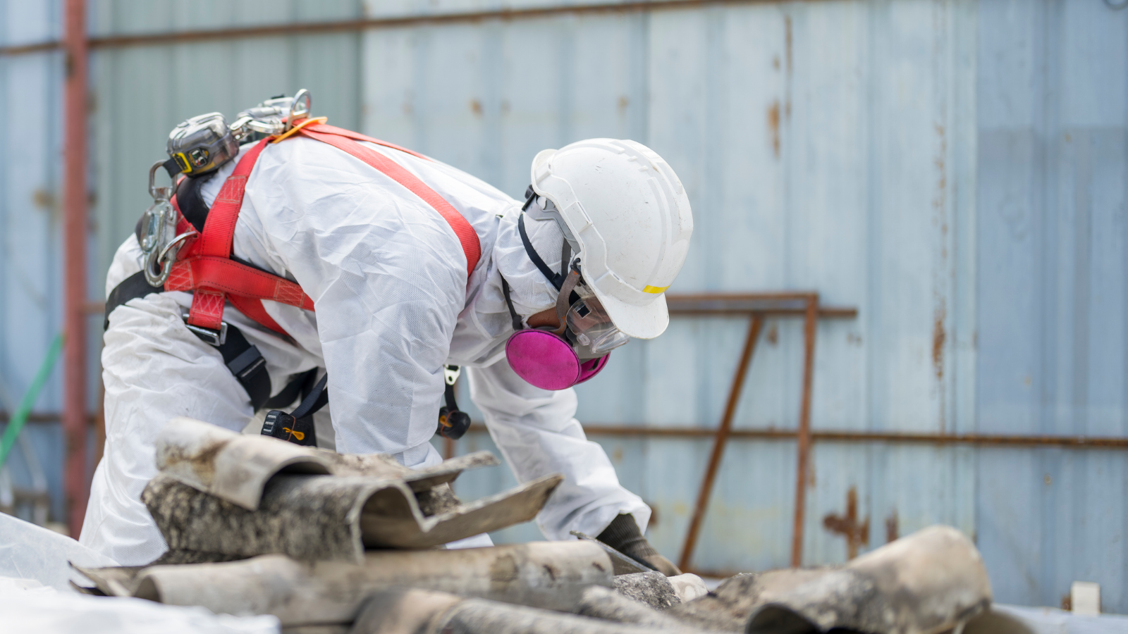 Man in HAZMAT suit removing asbestos. 