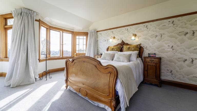 The main suite is particularly grand and comes with its own sitting area. Photo: Harcourts