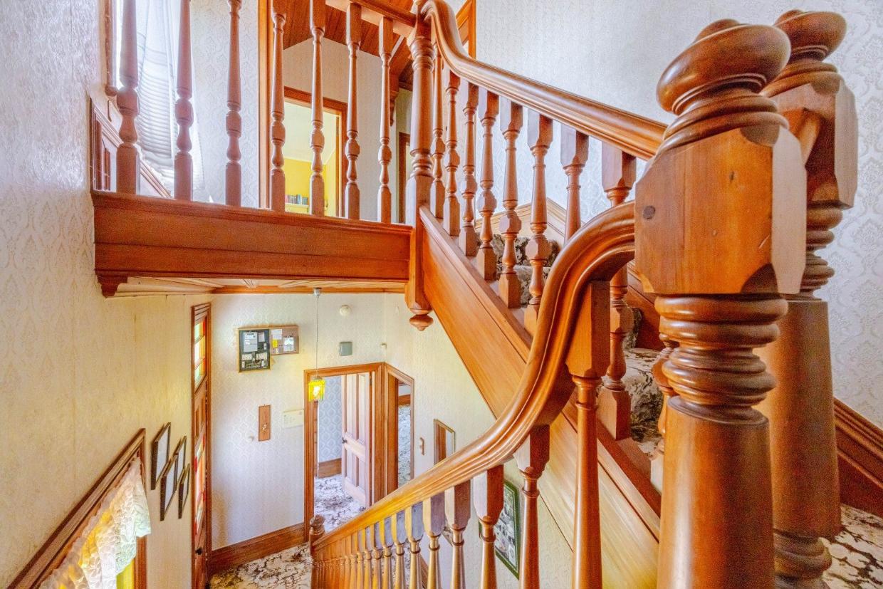 The listing notes the home now includes an inside toilet, though the original outhouse remains on the grounds.