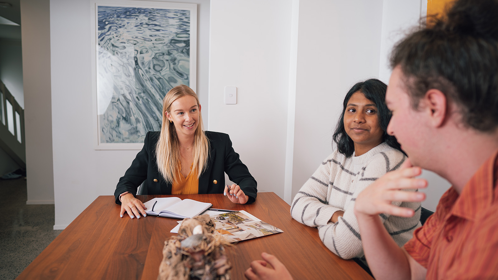 Couple at table with real estate agent. 