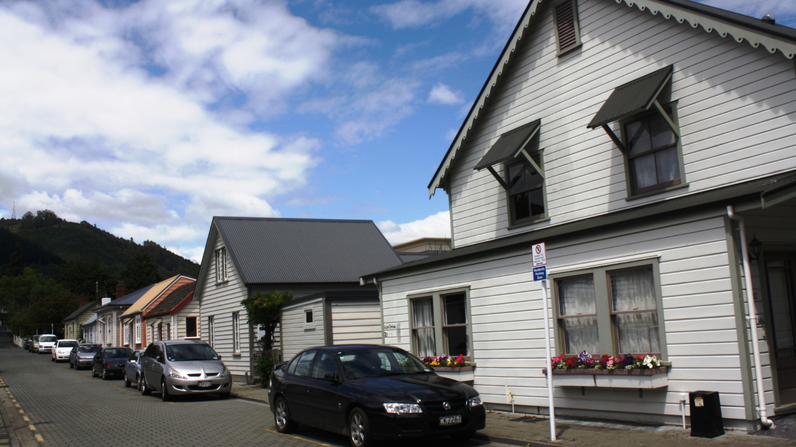 White boarding house on street in NZ. 